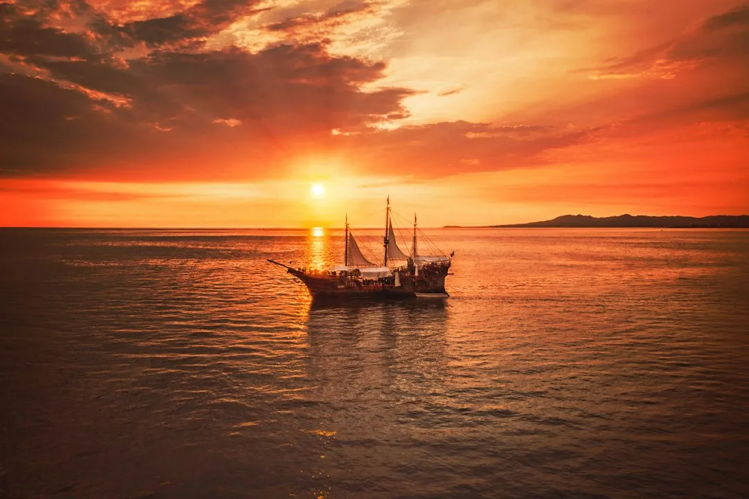 Sailing boat on a calm sea at sunset